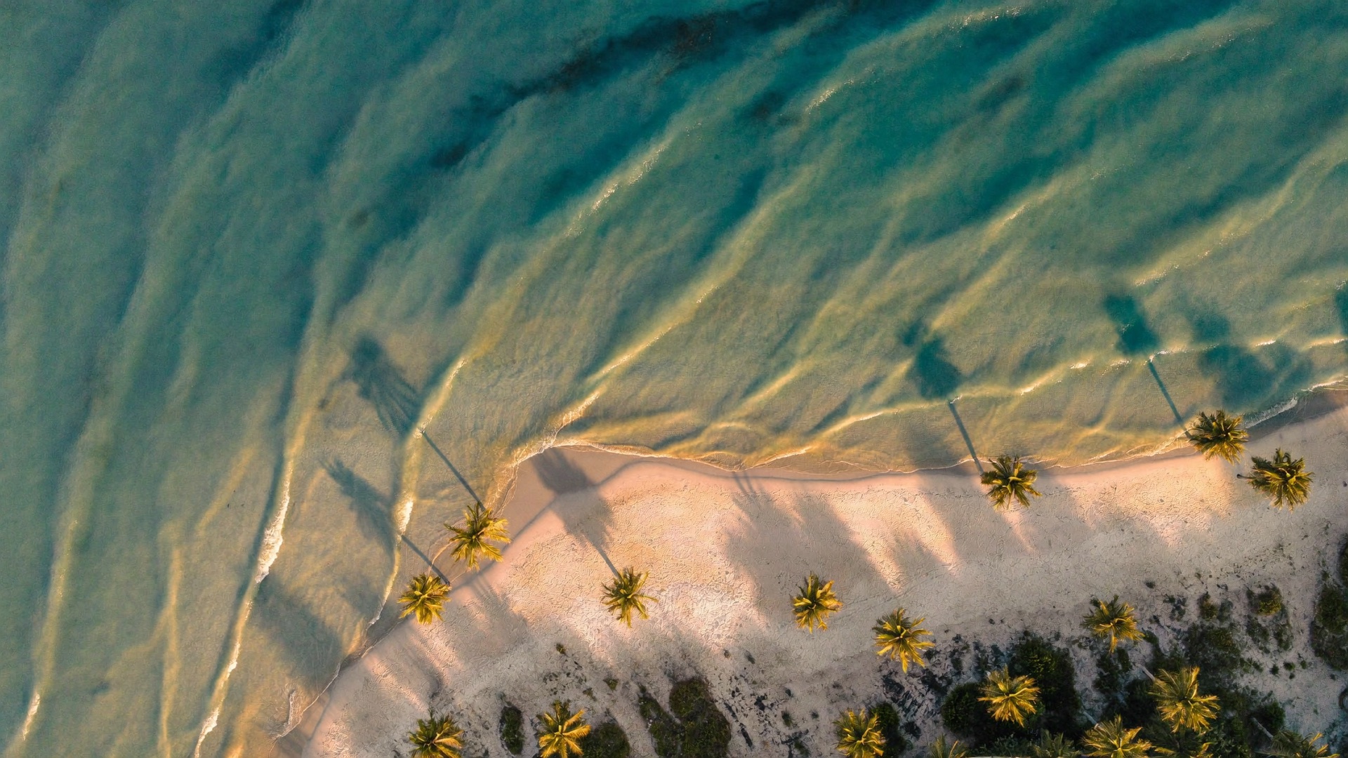 Aerial view of a turquoise Florida coastline at golden hour